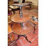 A George III mahogany dumb waiter, circa 1780, with three graduated tiers separated by turned