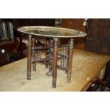 An Indian brass tray top occasional table