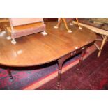 A George IV mahogany drop leaf dining table, circa 1825, the top with D shape leaves above ring