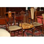 Two Edwardian mahogany and inlaid elbow chairs together with a third single mahogany chair