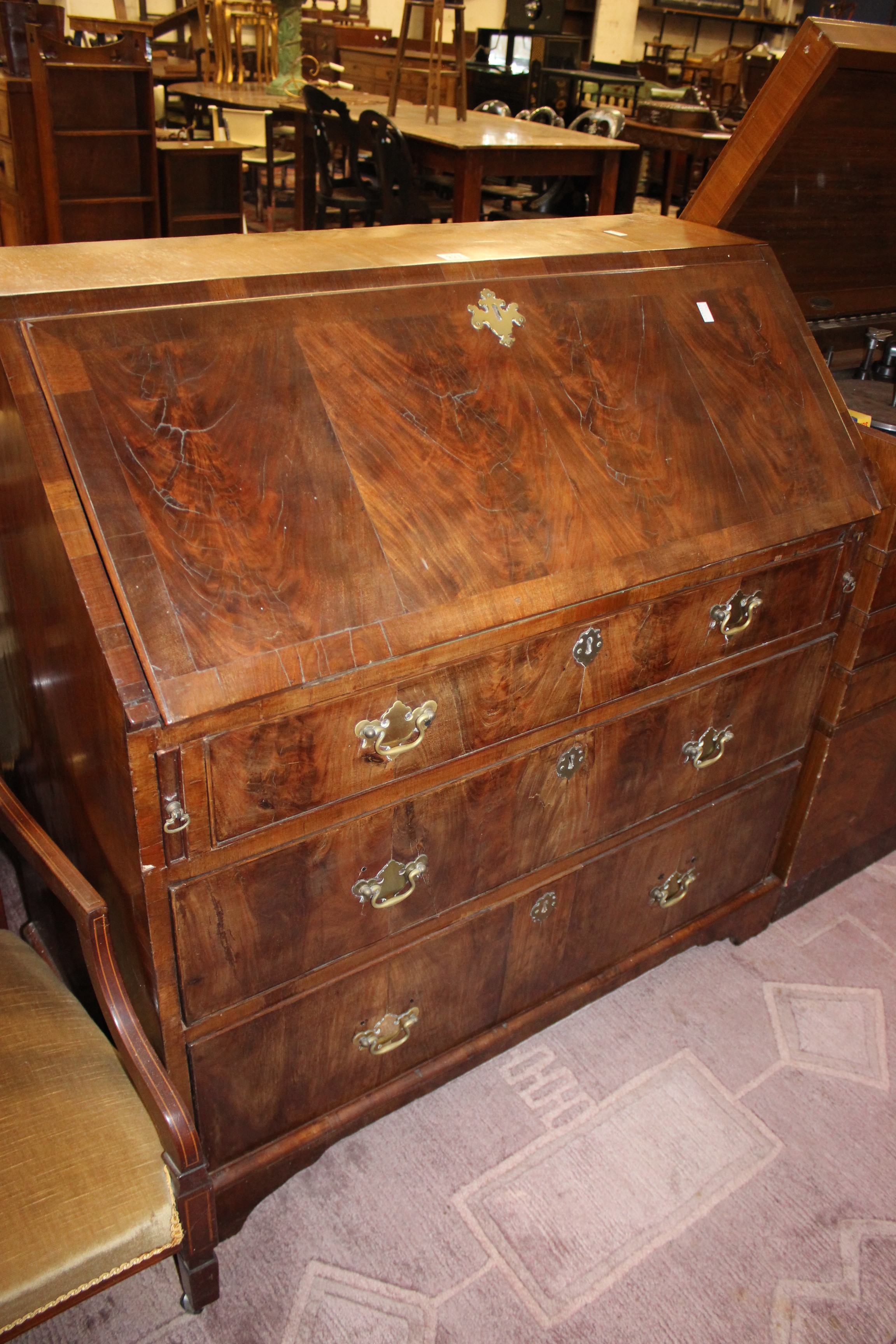 A George III figured mahogany bureau with three long drawers 103cm wide