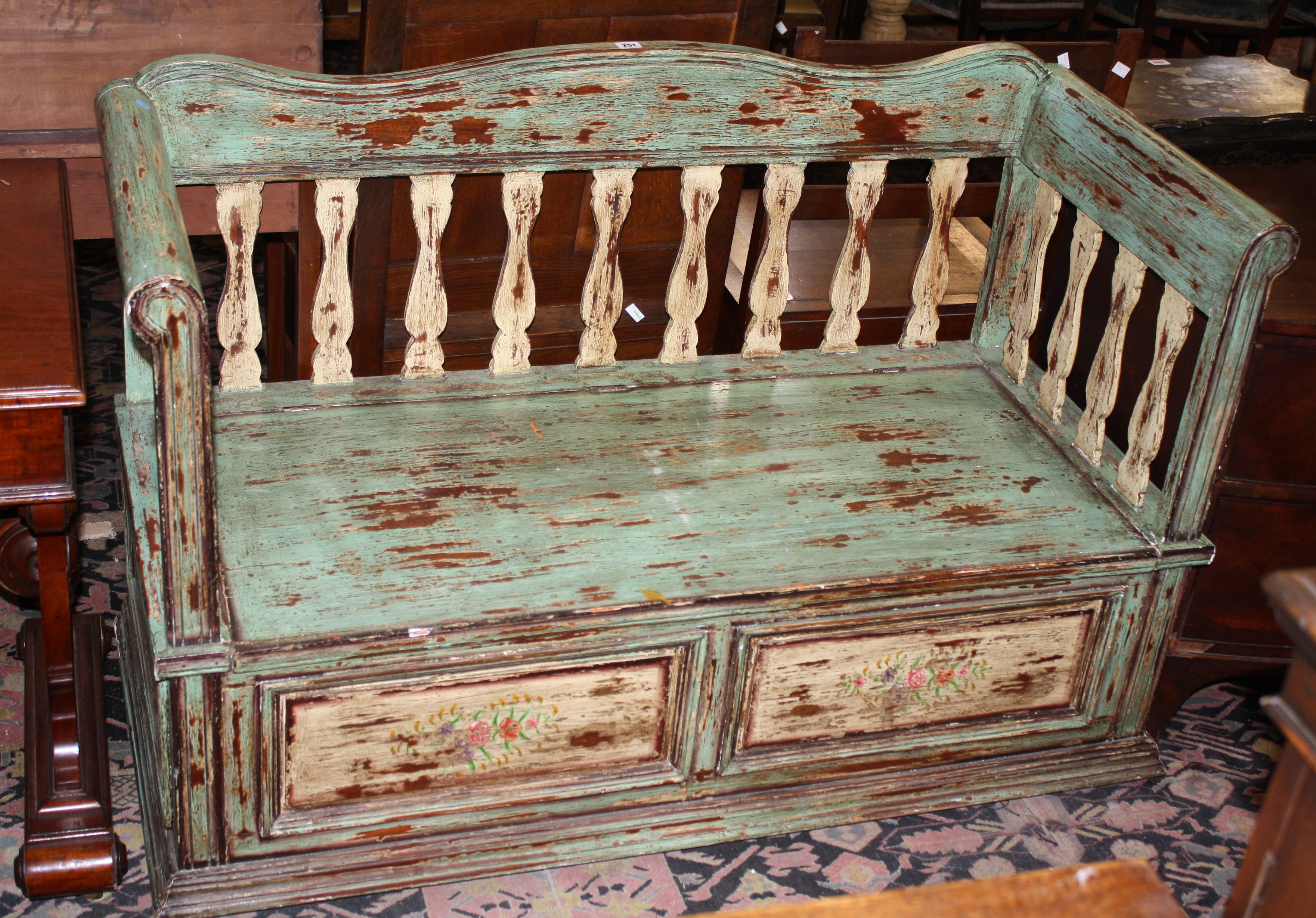 A North European style painted bench with a hinged seat135cm length