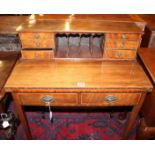 A late Victorian mahogany bonheur de jour, circa 1890, the back with banks of drawers flanking