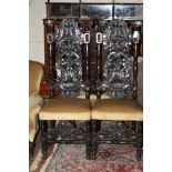 A pair of Victorian carved oak high back chairs each with upholstered seat