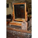 A Victorian mahogany toilet mirror and a carved bookshelf