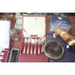 A cased set of silver teaspoons, silver handled knives, a spoon, napkin ring, a quantity of plated