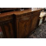 A mahogany breakfront cabinet enclosing a gramophone