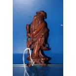 A Oriental carved wooden figure of a sage, 11cm high