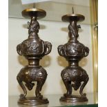 A pair of Oriental bronze candlesticks, 25cm high