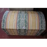 A domed upholstered trunk 70cm wide and a shaped two tier occasional table