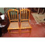 A pair of Edwardian line inlaid and cane seat chairs, a mahogany cake stand, firescreen and a