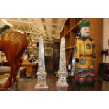 A pair of Chinese obelisks, an Oriental pottery figure and a Tang pottery horse (3)