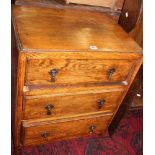 An oak three drawer bedside chest