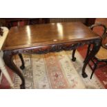 A 19th Century Irish mahogany console table with carved acanthus leaf decoration and central shell