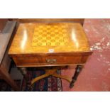 An inlaid walnut games table with a frieze drawer on ring turned legs joined by stretcher 61cm wide