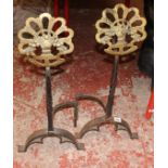 A pair of andirons with fruiting basket decoration