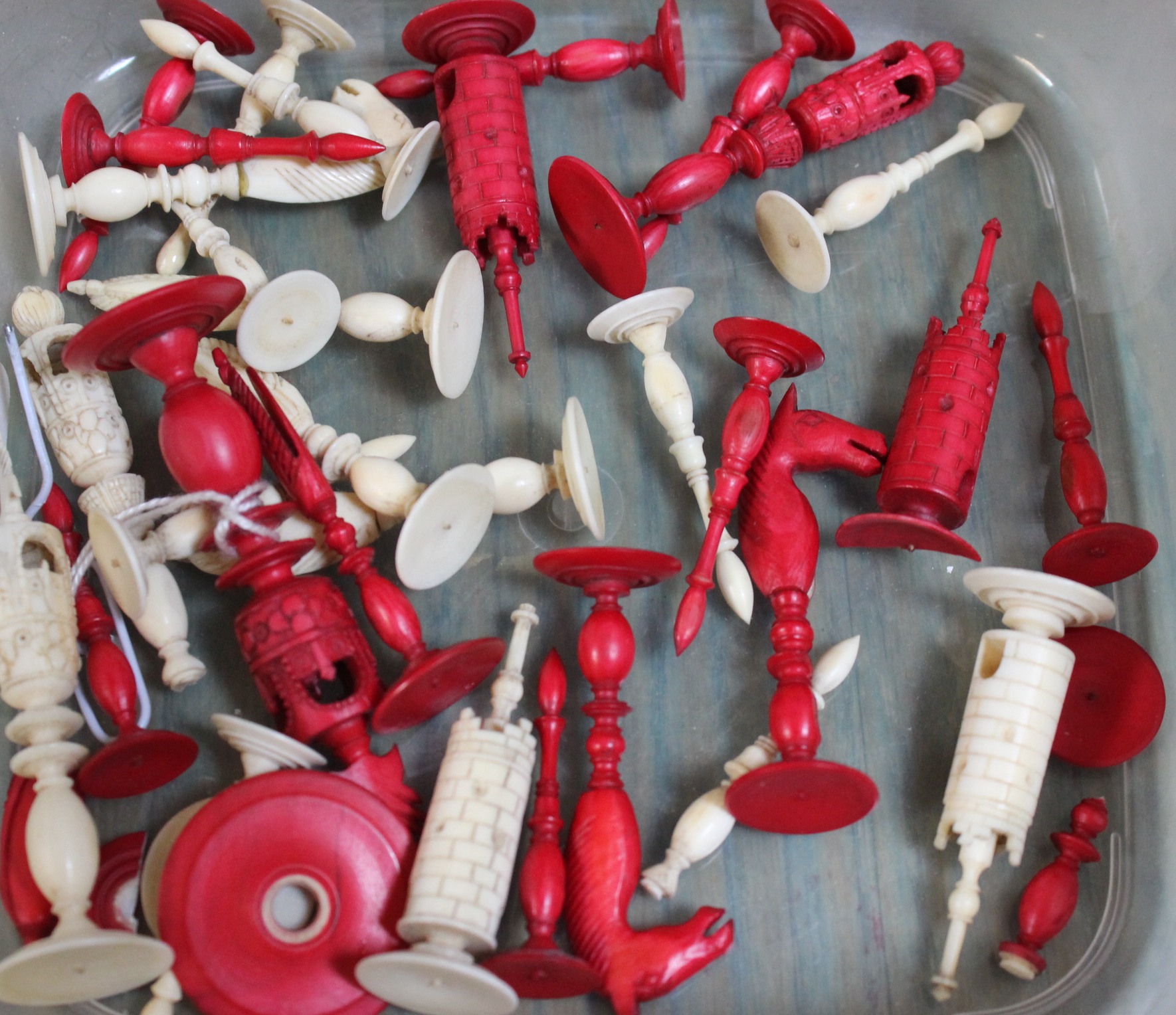 A quantity of assorted stained ivory chess pieces (af)