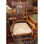 A 17th Century style oak and cane armchair