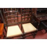 An oak bureau, bookcase, drop leaf table, pair of ladderback chairs, cake stand, oak trolley and a