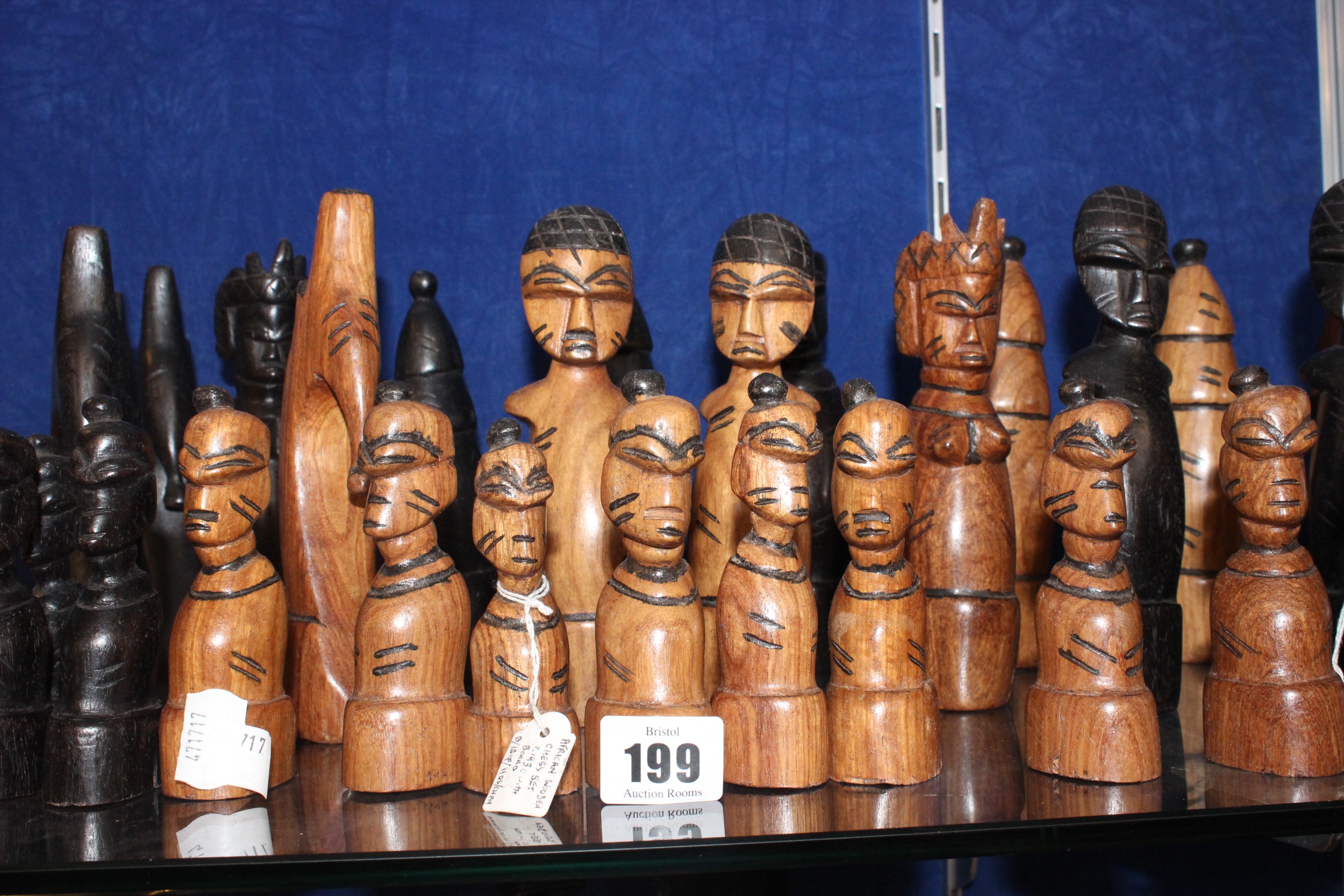 A 20th Century African wooden chess set (32 pieces) and another smaller chess set