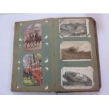 AN EARLY 20TH CENTURY ALBUM of military postcards to include the The King at the Front, Army