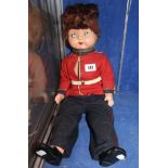 A doll wearing a Guards' Uniform wearing Cinderella shoes!, 53cm tall.