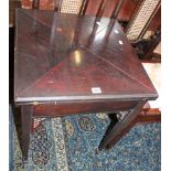 An Edwardian mahogany envelope card table with pierced spandrels on square tapering legs and spade