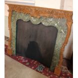 A carved pinewood mantelpiece with fitted slips and fabric backing 118cm high, 134cm wide