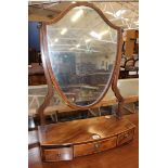 A George III mahogany shield shaped dressing table mirror on bowfronted base