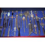 A collection of forty one letter openers from various parts of the world and Swansea displayed in