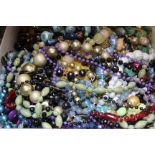 A quantity of costume jewellery to include beaded necklaces, chains, clip on earrings, mid/ late