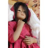 A boxed Annette Himstedt doll, girl in a red cloak