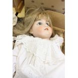 A large Armand Marseille doll, bisque head, open blue eyes, composition body, 81cm long approx.