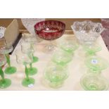 Six green pressed glass dessert bowls, five tall green stemmed wine glasses,a red bohemian glass