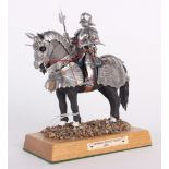 A Finely Built White Metal Model of a Mounted German Gothic Knight mounted on a wooden plinth with