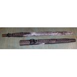 An African geometrically carved and wire work wooden handled dagger and sheath