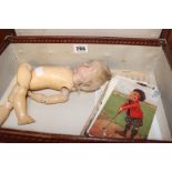 A Kammer & Reinhardt bisque head doll and a small quantity of assorted postcards in a case