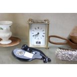 A decorative Servres style Easter Egg, two Inuit seals, brass effect carriage clock and pair of