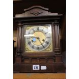 A Oak cased mantel clock with German eight-day gong striking movement, 34cm high (af)