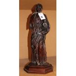 A Continental sculpted walnut model of a female saint, late 17th / early 18th century, portrayed