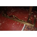 Three Edwardian brass fenders and a further example with scrolling front and sides 135cm wide