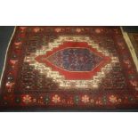 A Middle Eastern red ground rug 155 x 117cm