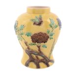 A Chinese yellow-ground vase, 20th century, applied with flowers and birds glazed in green, blue and