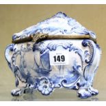 A late 19th Century Continental blue and white faience casket in rococo style, 17cm high
