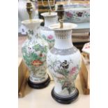 A pair of modern Chinese porcelain famille rose baluster vases, with turned wood bases and decorated