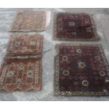 Four Persian carpets and saddle bags