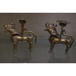 A set of four Dog of Fo bras candleholders, 10cm high