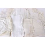 A collection of household linens and costume, including: tablecloths, mats, guest towels, tray