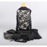 A quantity of late 19th/early 20th century black lace, including: flounces, a large shawl, part of a