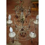 A Victorian cast metal standard oil lamp and a small chandelier with purple coloured drops